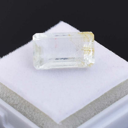 Clear, rectangular crystal or gemstone with flat facets.