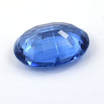 Faceted blue gemstone with an oval cut.