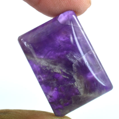 Purple gemstone or crystal with white inclusions, likely amethyst.