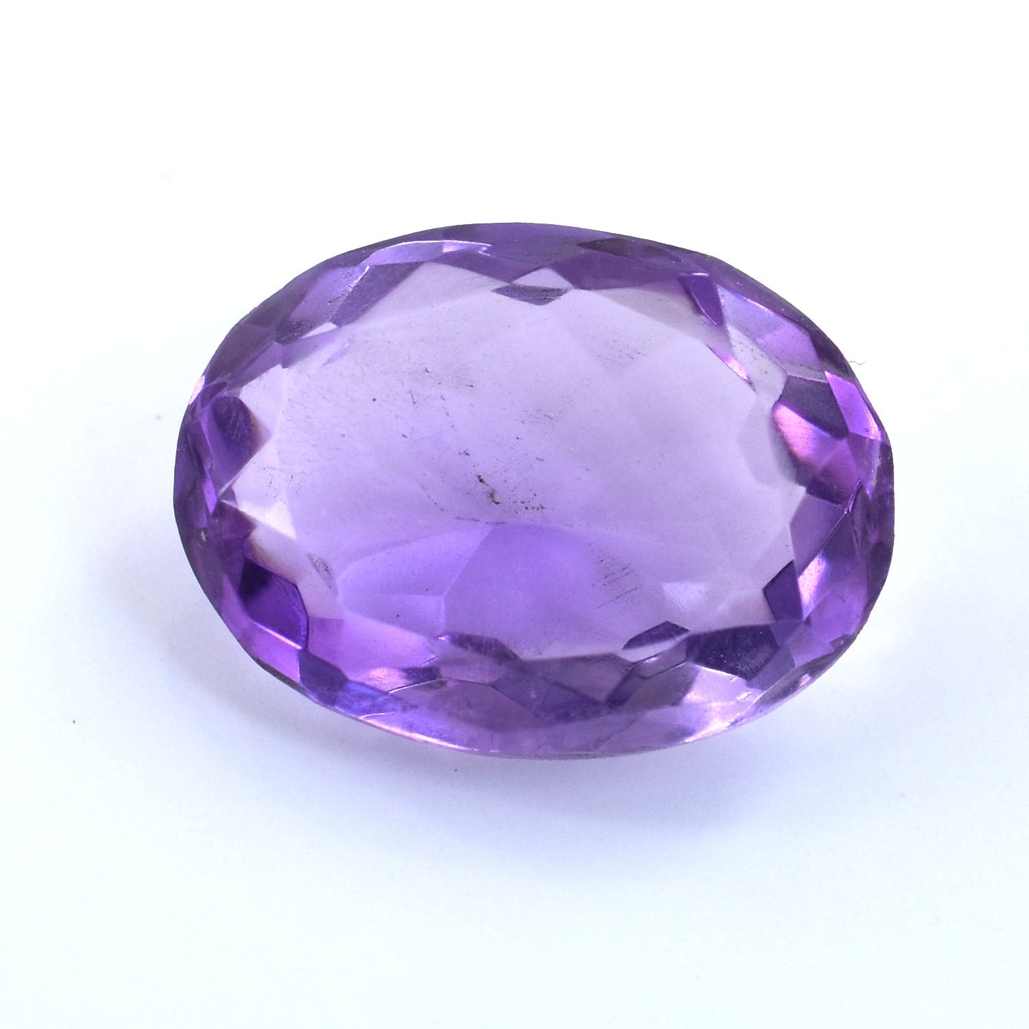 Oval-cut purple gemstone with faceted edges.