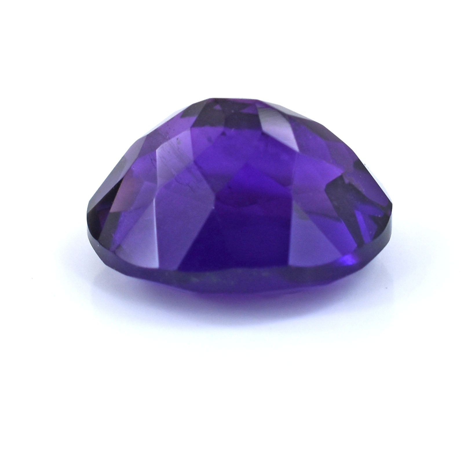 Faceted purple gemstone with a deep violet hue.