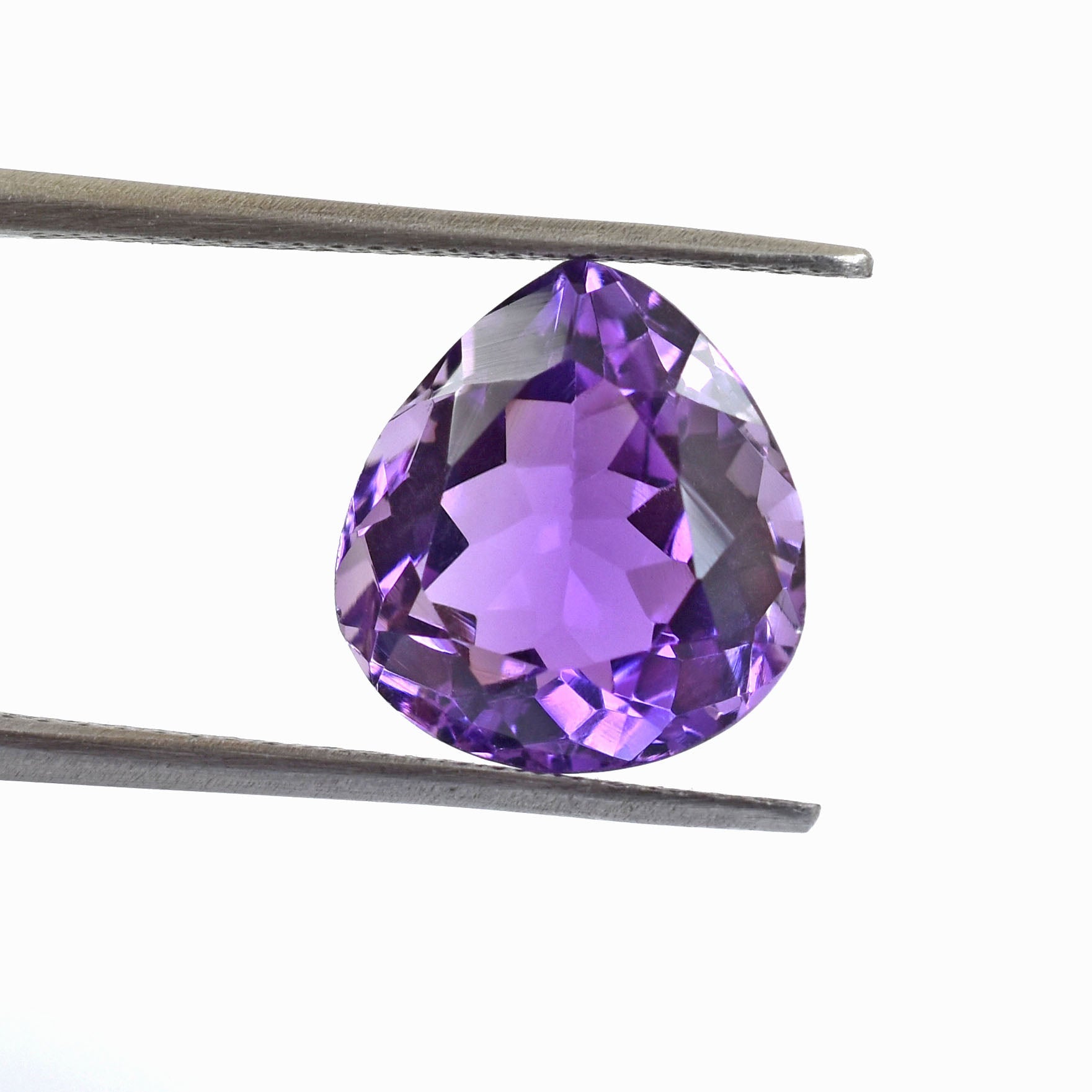 Pear-shaped purple gemstone held by tweezers.