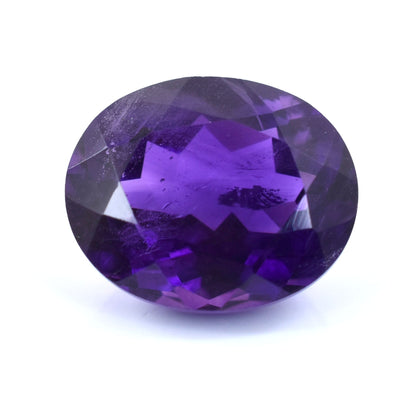 Oval-cut purple gemstone with faceted surfaces.