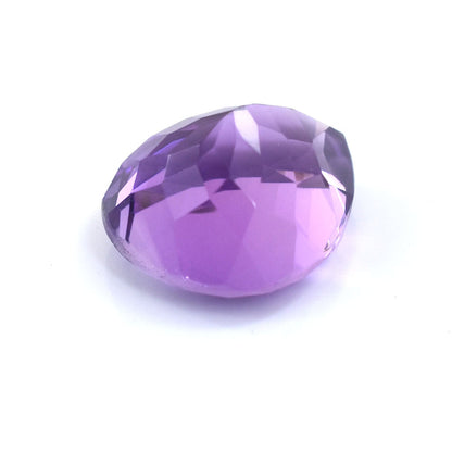 Oval-cut purple gemstone with facets reflecting light.