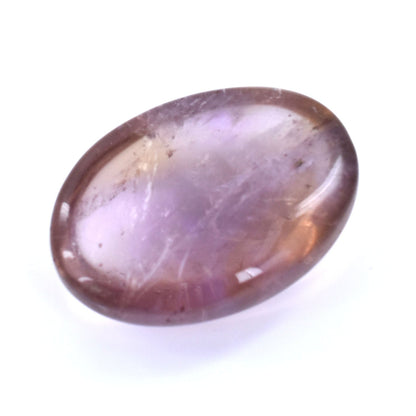 Oval-shaped, translucent gemstone with purple and amber hues.