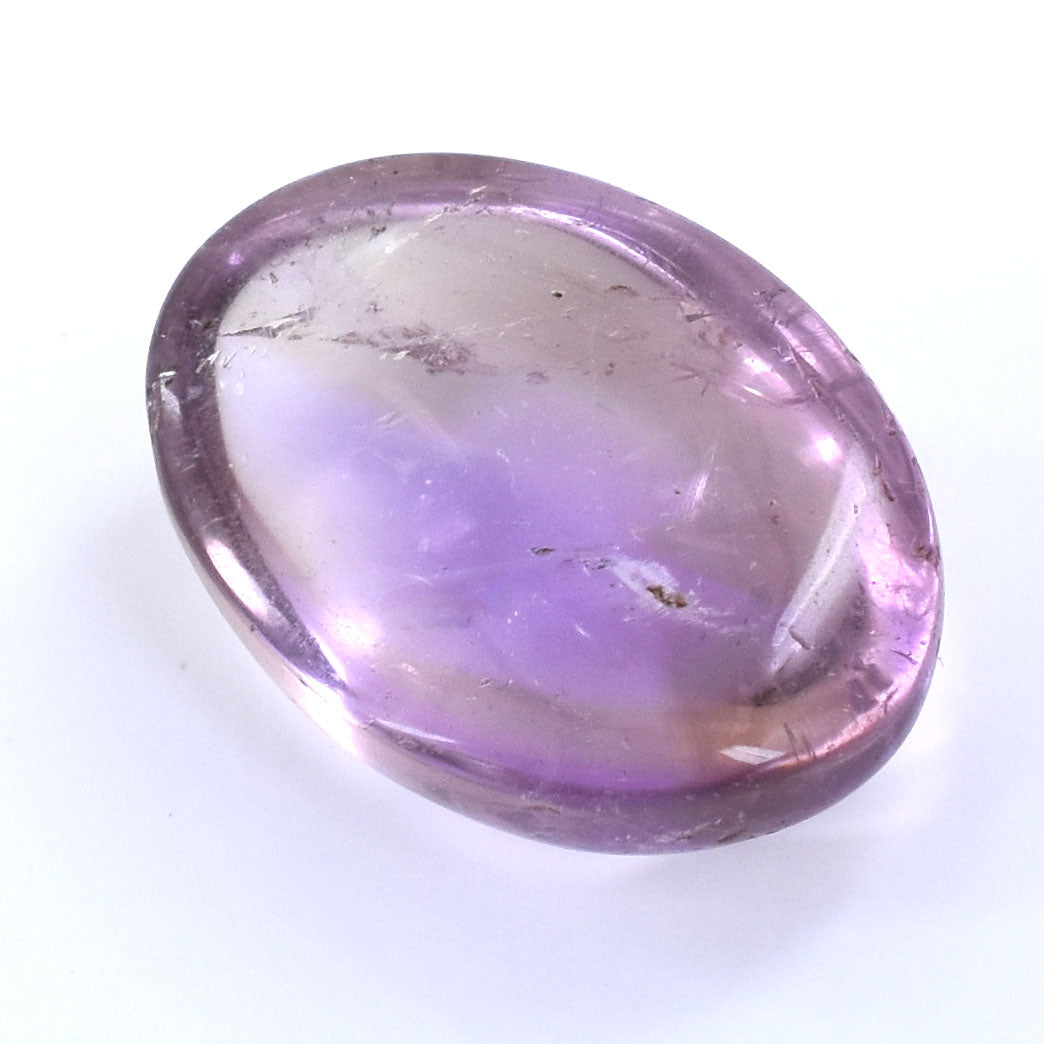 Oval-shaped purple gemstone with slight inclusions and a smooth, polished surface.