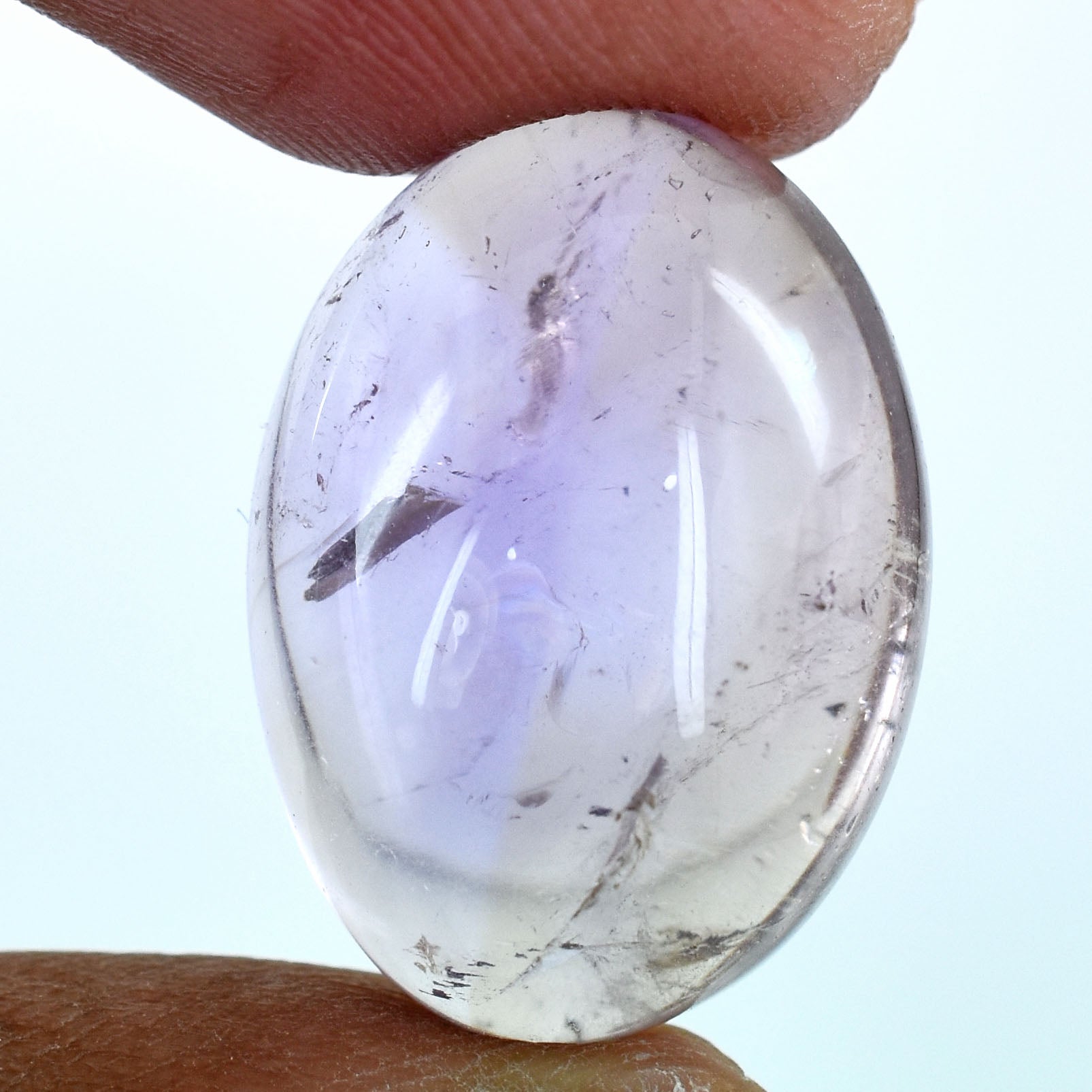 Smooth, oval-shaped gemstone or crystal with a pale lavender hue.