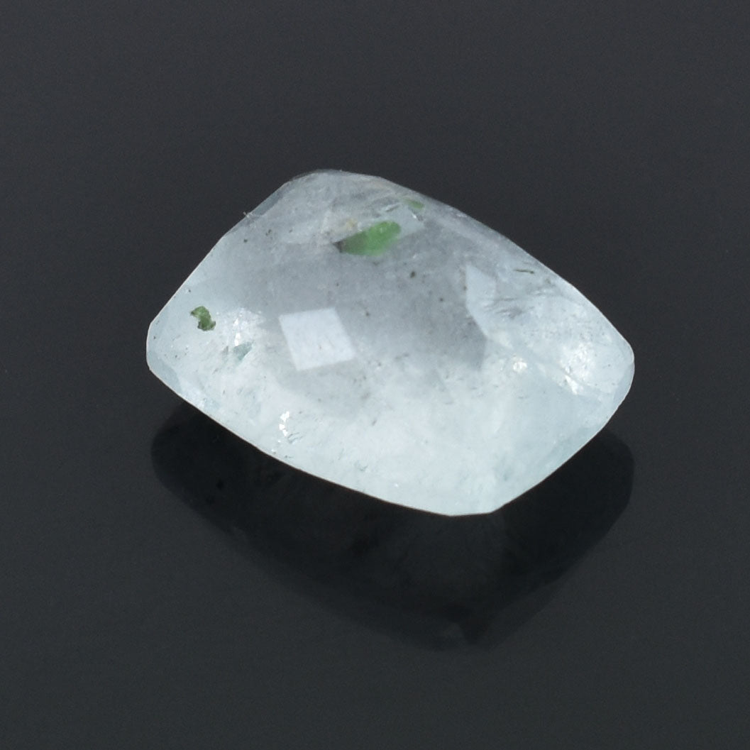 Smooth, white, rounded gemstone or crystal with faint green inclusions.