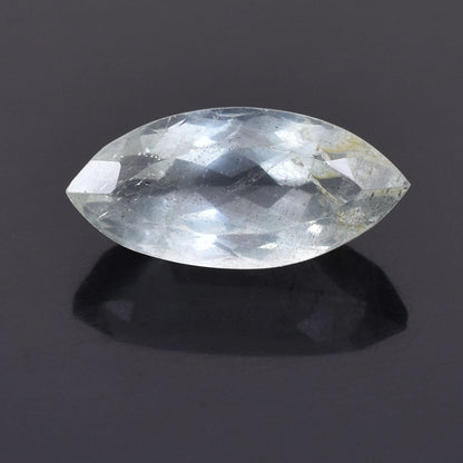 Faceted, marquise-cut clear gemstone or crystal reflecting light.