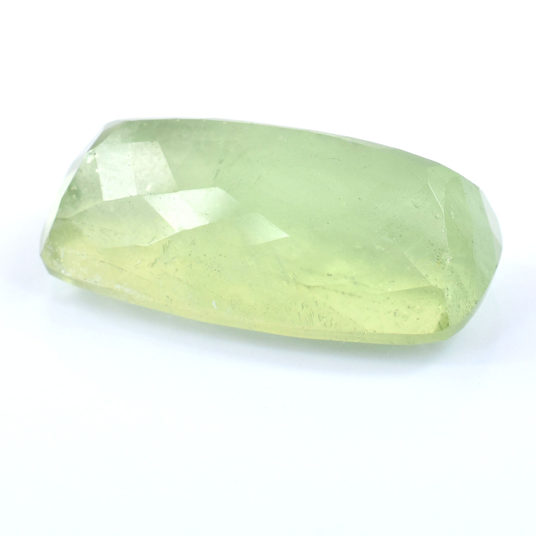 Pale green gemstone with a faceted, elongated rectangular shape.