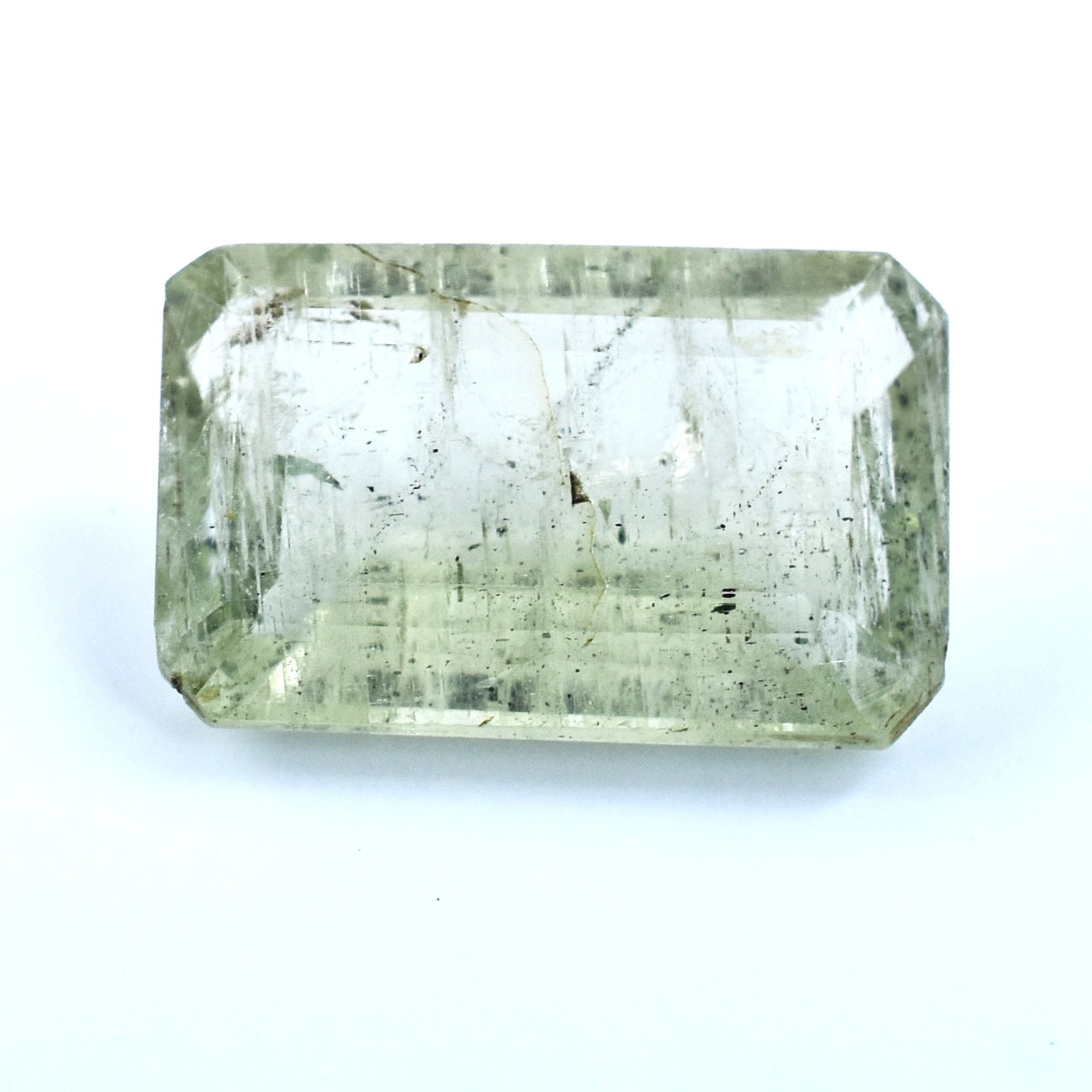 Rectangular cut pale green gemstone with visible inclusions.