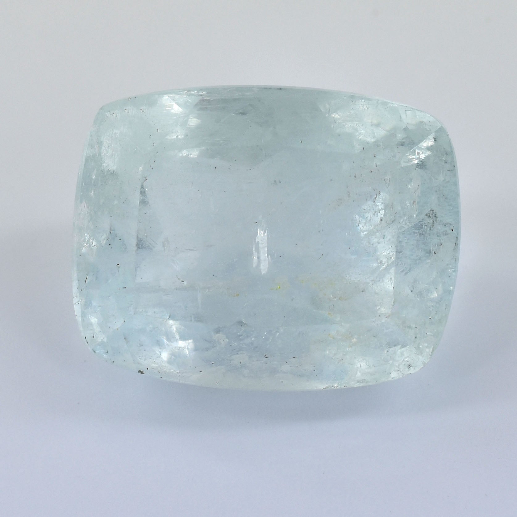 Pale blue-green gemstone with a cushion cut shape.