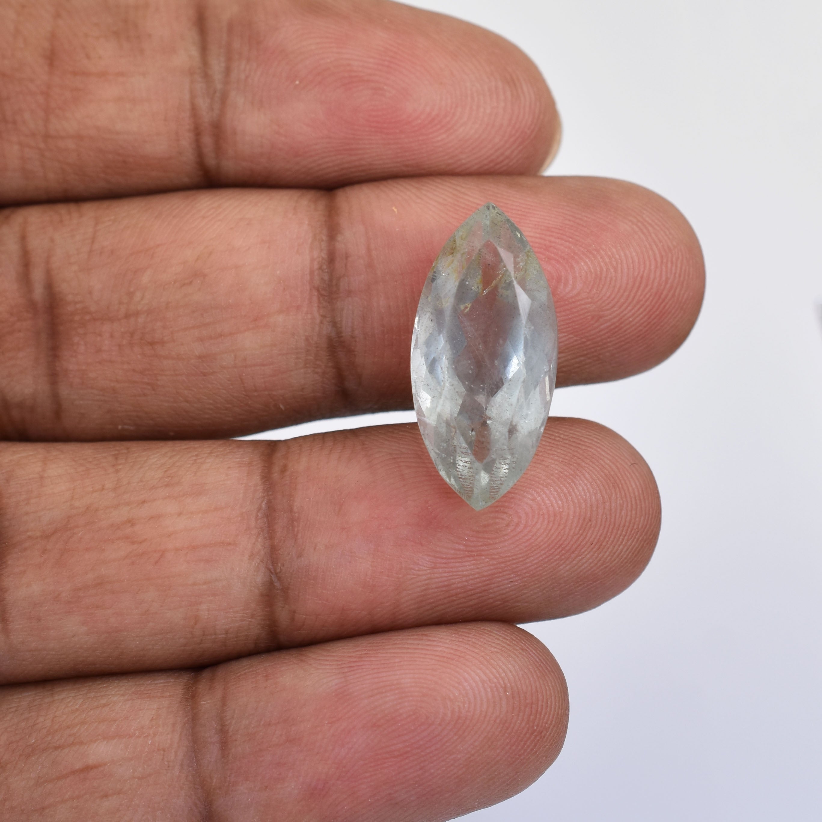 Clear, faceted gemstone with an elongated marquise cut shape.