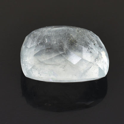 Polished, translucent white crystal or gemstone with a rounded, cabochon-like shape.