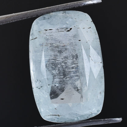 Pale blue, rectangular-cut gemstone with visible inclusions and facets.