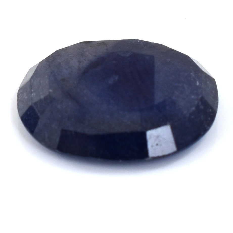 Dark blue oval-shaped gemstone with faceted cuts.