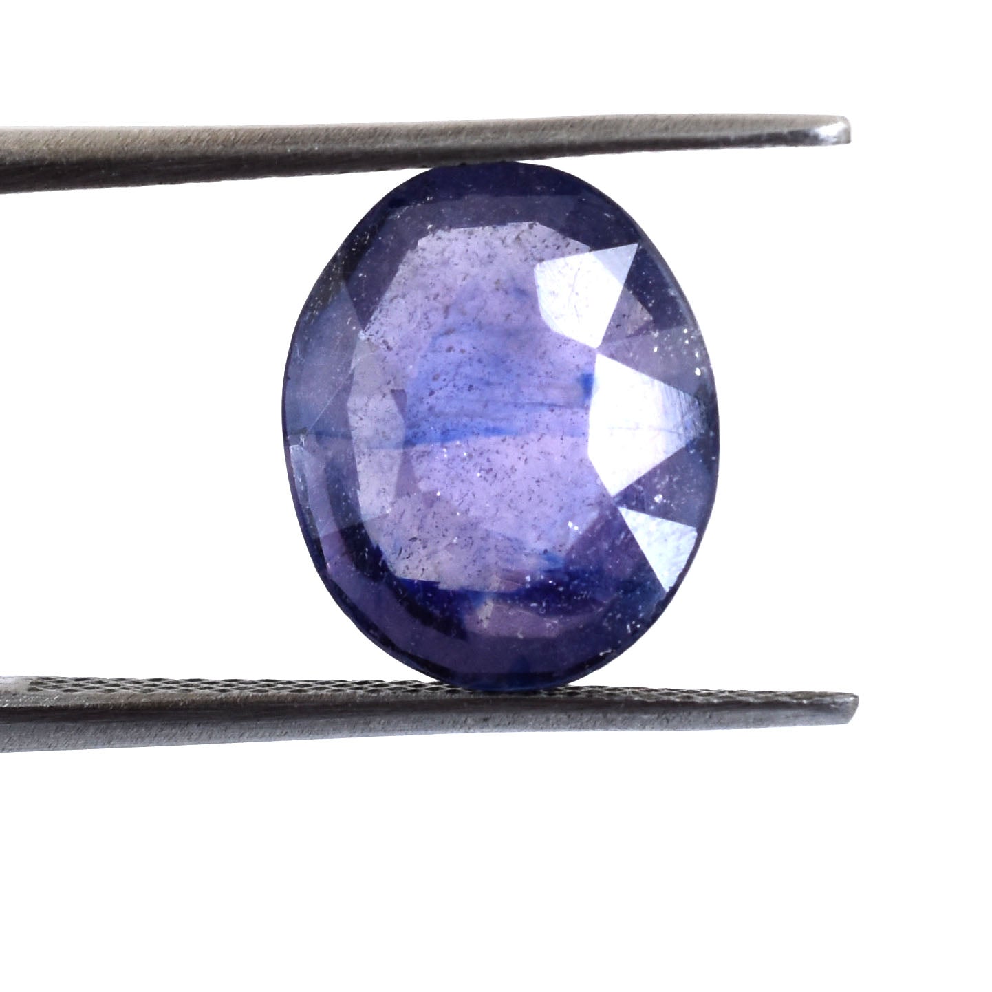 Oval-cut purple gemstone held by tweezers.