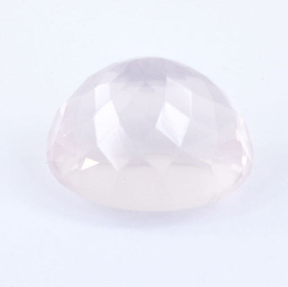 Pale pink, translucent gemstone with a smooth, rounded cabochon cut.