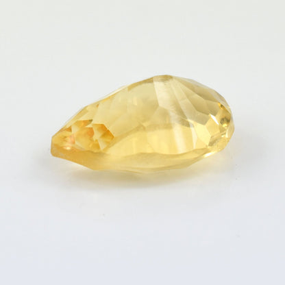 Faceted yellow gemstone with a teardrop shape.