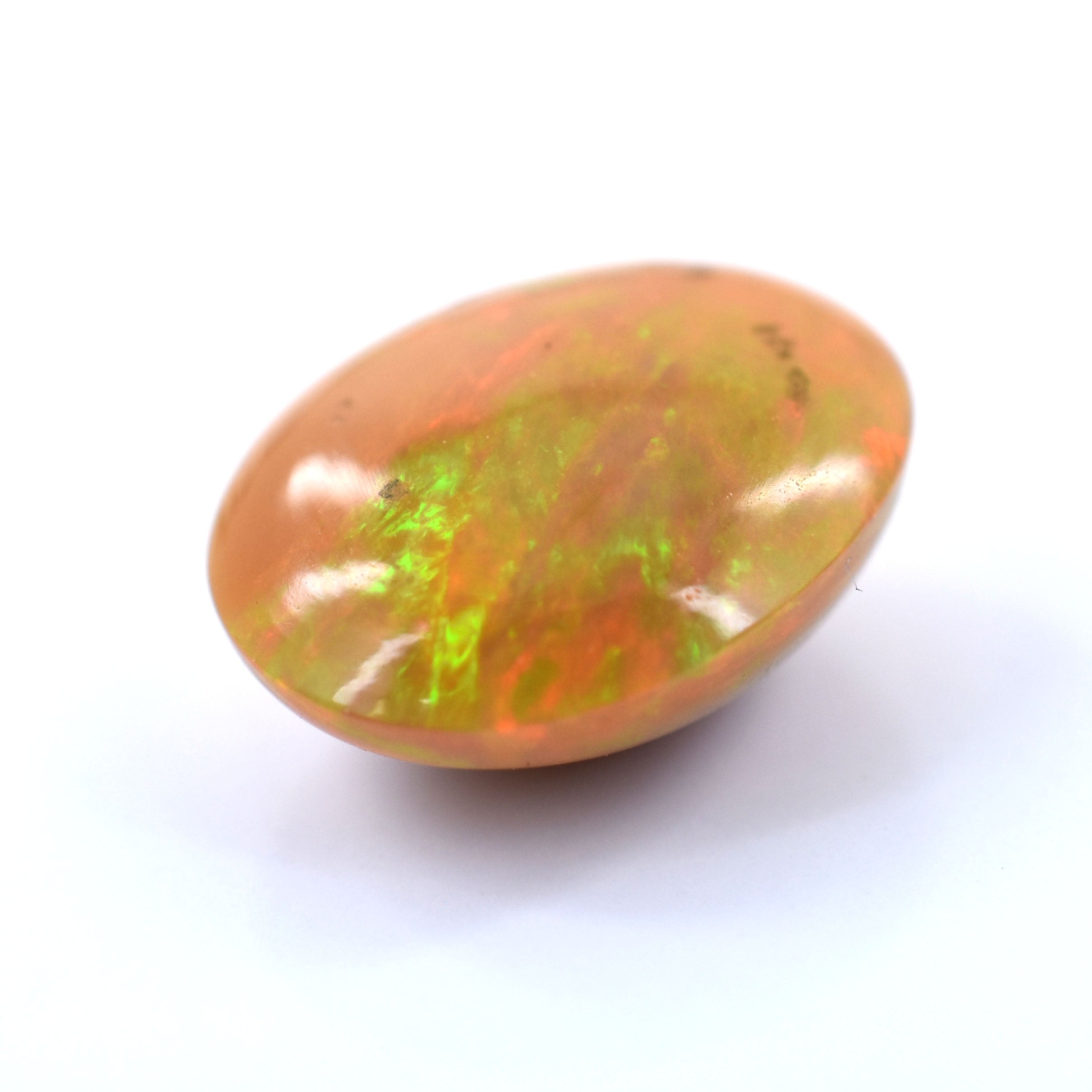 Oval-shaped opal gemstone with flashes of green and orange fire.