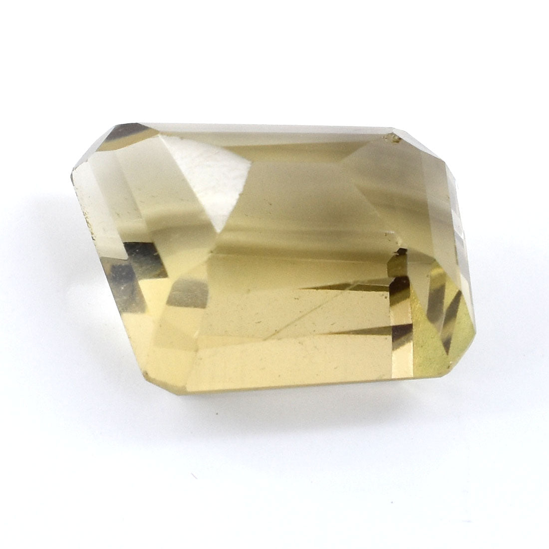 Faceted pale yellow gemstone with a rectangular shape and angled cuts.