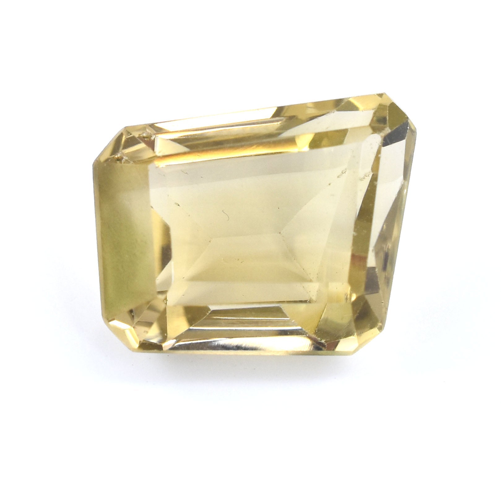 Faceted yellow gemstone with an emerald-cut shape.