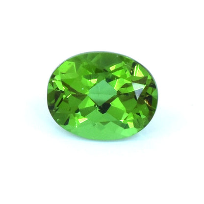 Faceted oval-cut green gemstone with brilliant clarity and sparkle.