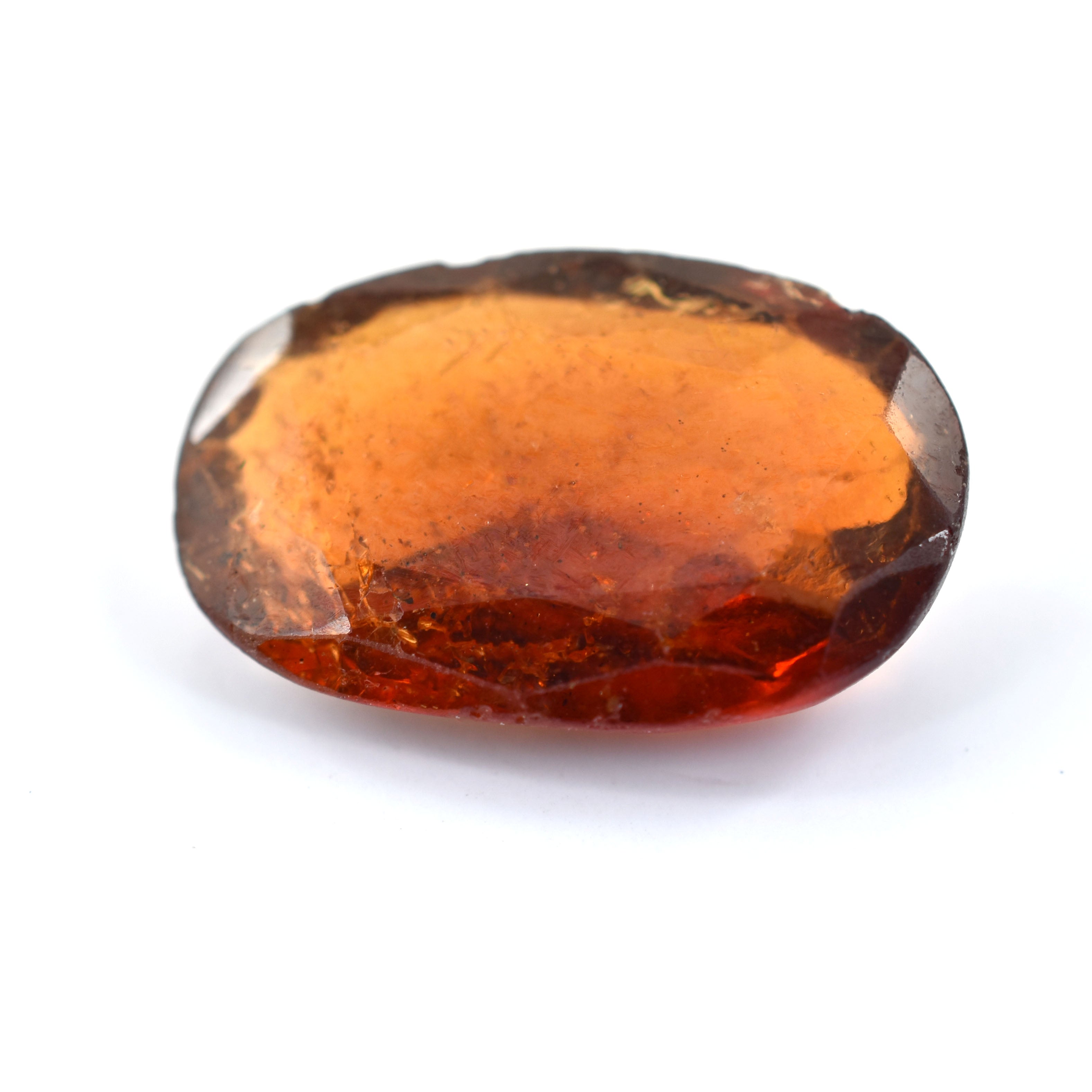 Oval-shaped amber or topaz gemstone with a faceted cut.