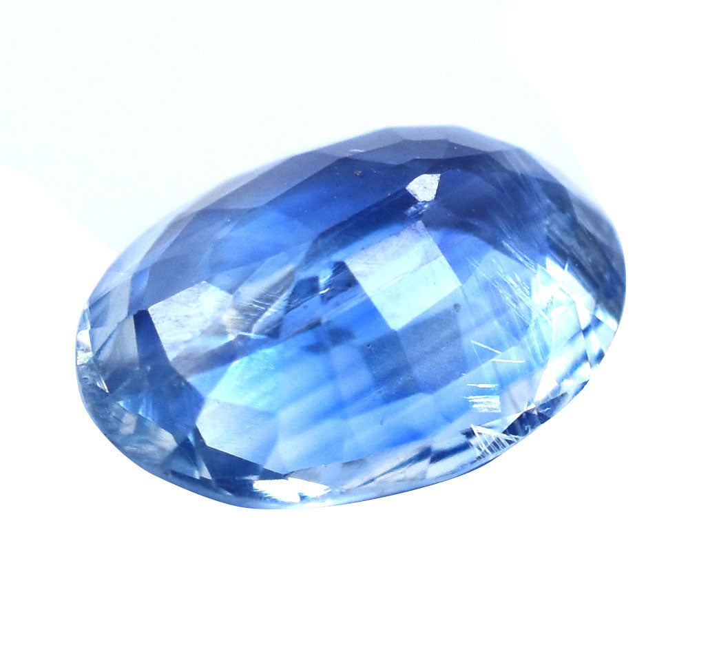 Faceted blue gemstone or crystal with an oval shape.