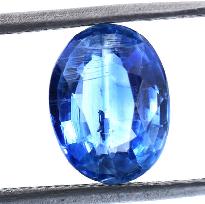 Brilliant oval-cut blue gemstone, likely a sapphire.