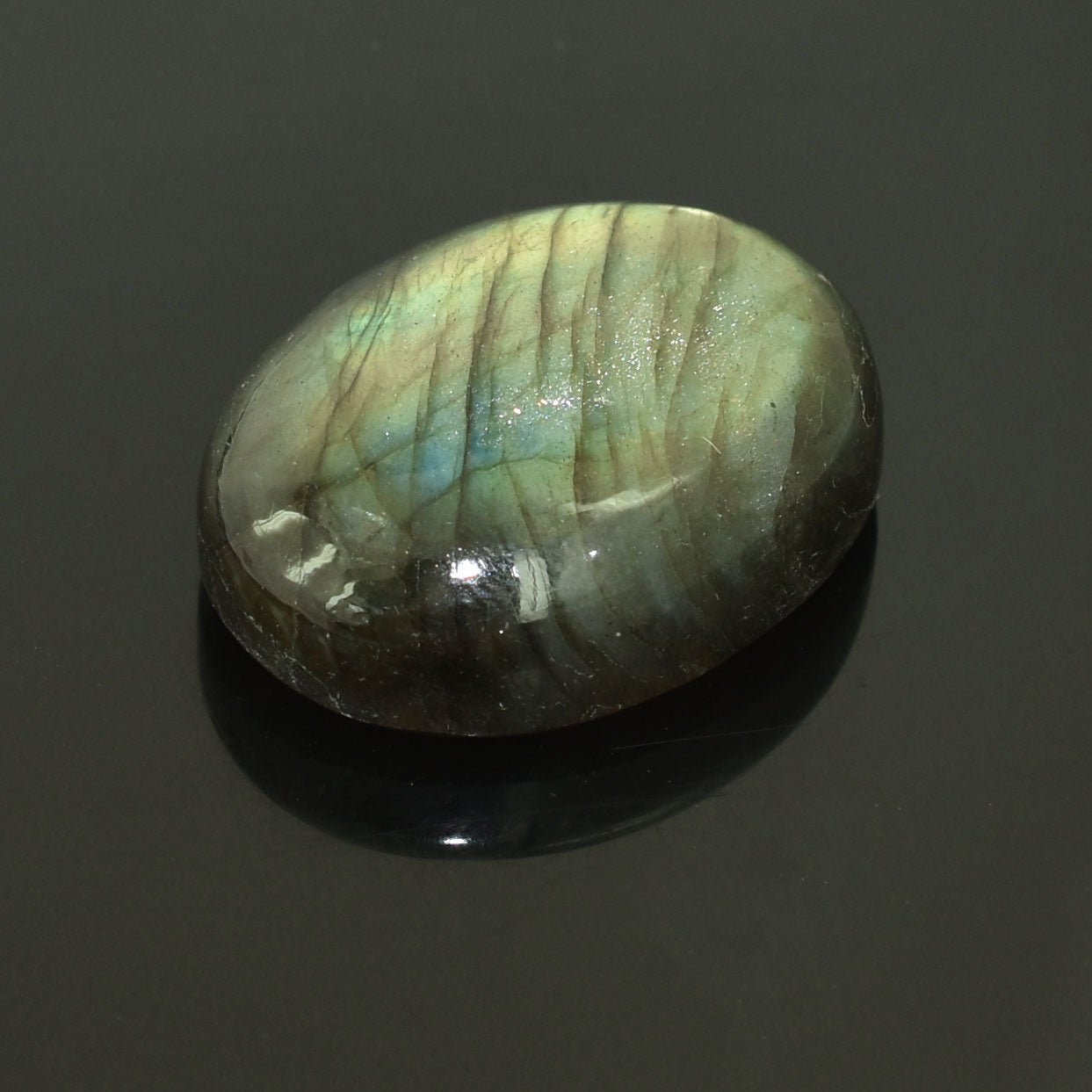 Oval-shaped labradorite gemstone with iridescent blue-green flashes.