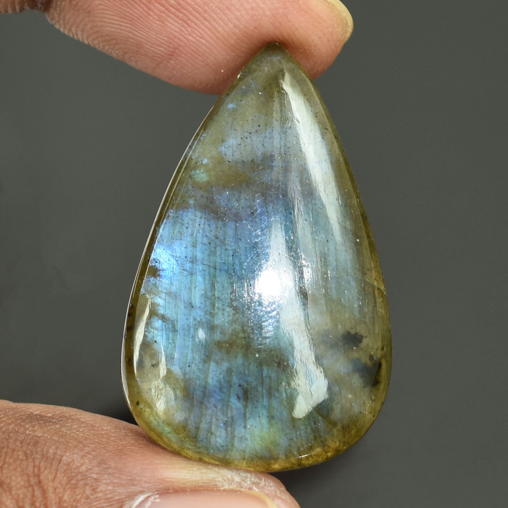 Teardrop-shaped labradorite gemstone with blue and green iridescent flashes.