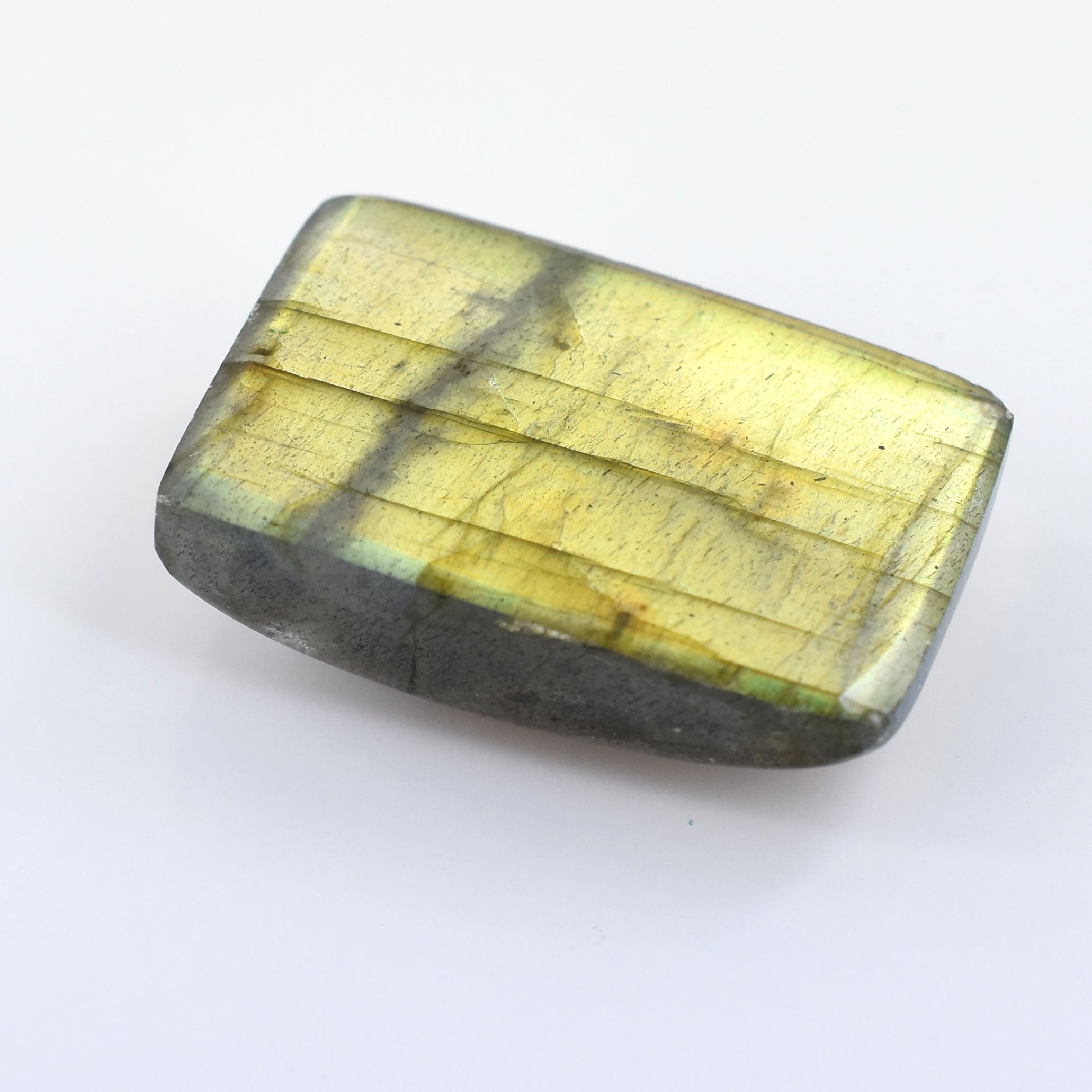 Polished labradorite gemstone with iridescent yellow-green flashes.