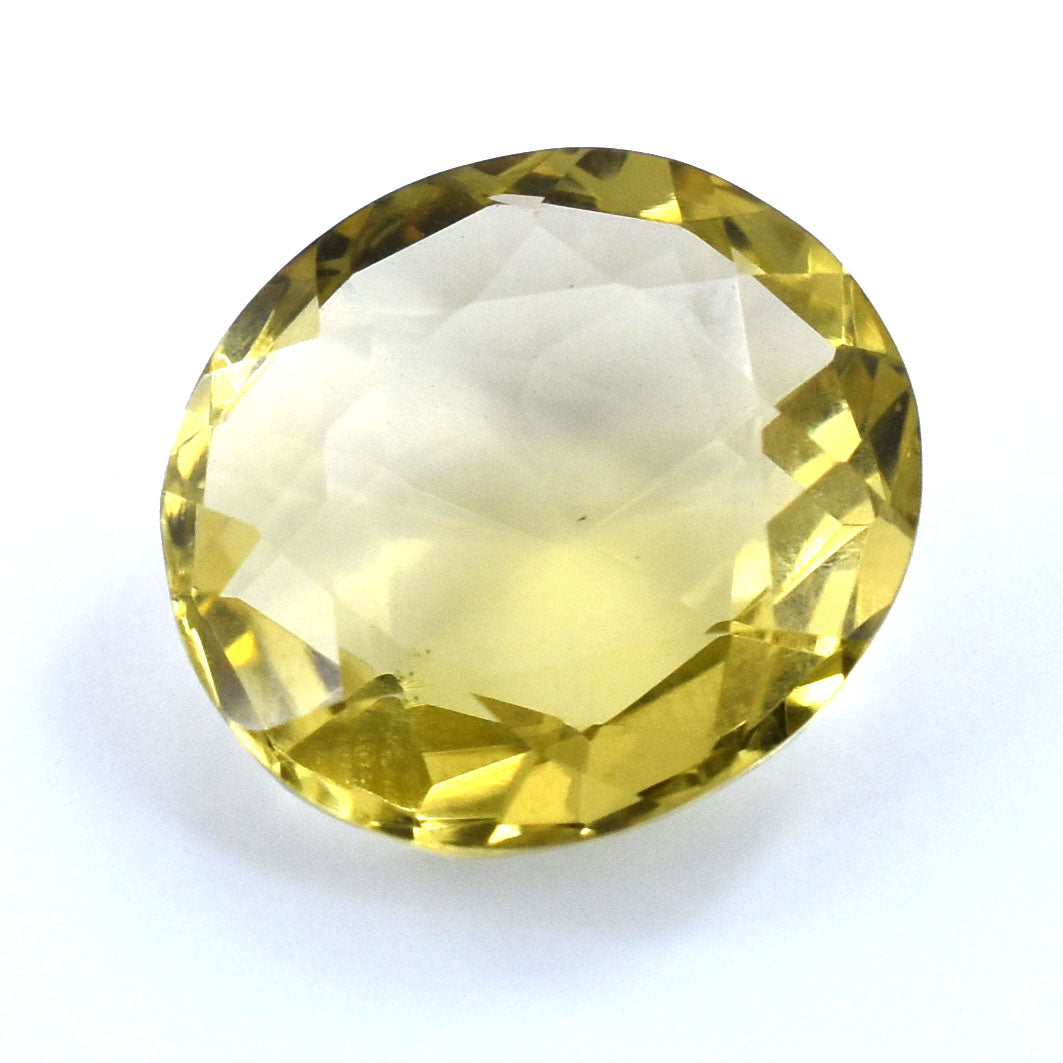 Faceted yellow gemstone with a round, oval shape.