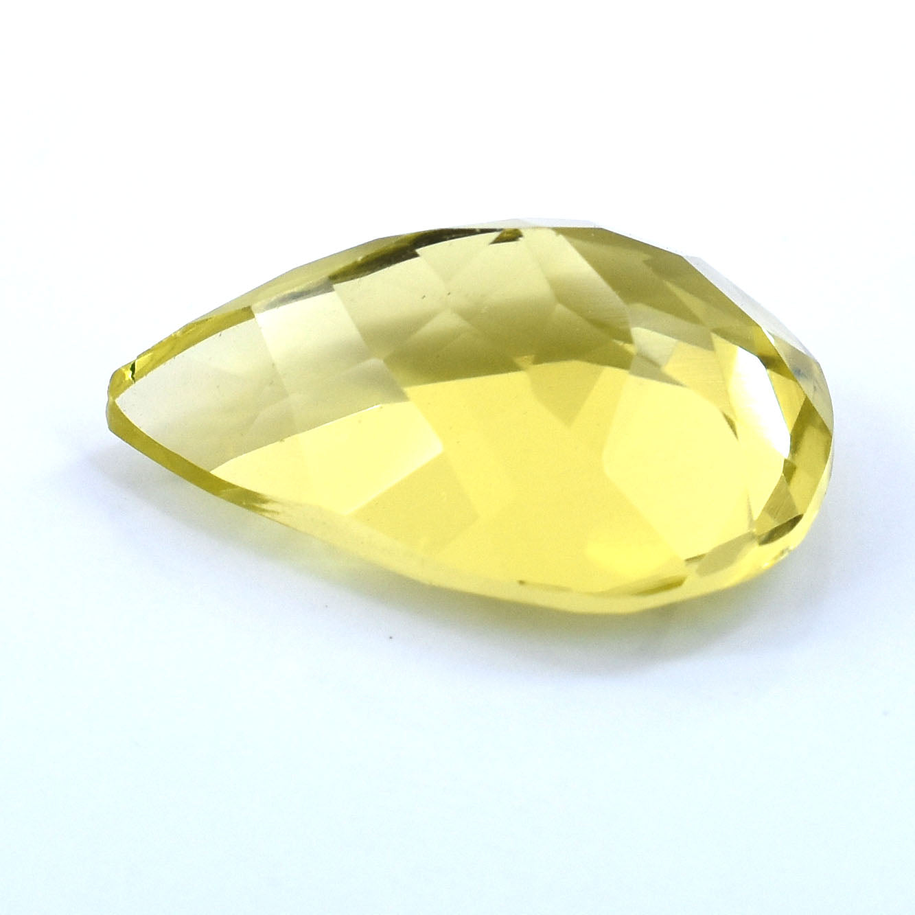 Faceted teardrop-shaped gemstone in pale yellow.