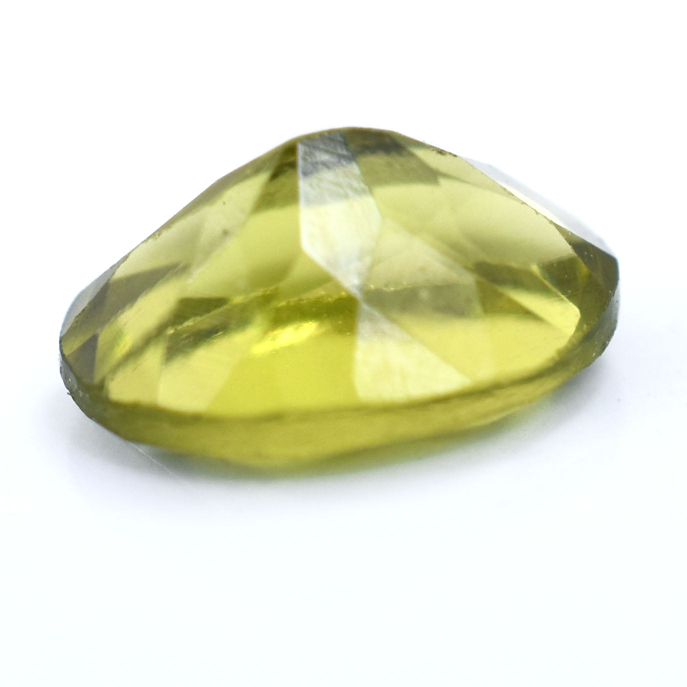 Faceted yellow-green gemstone with a pear-shaped cut.