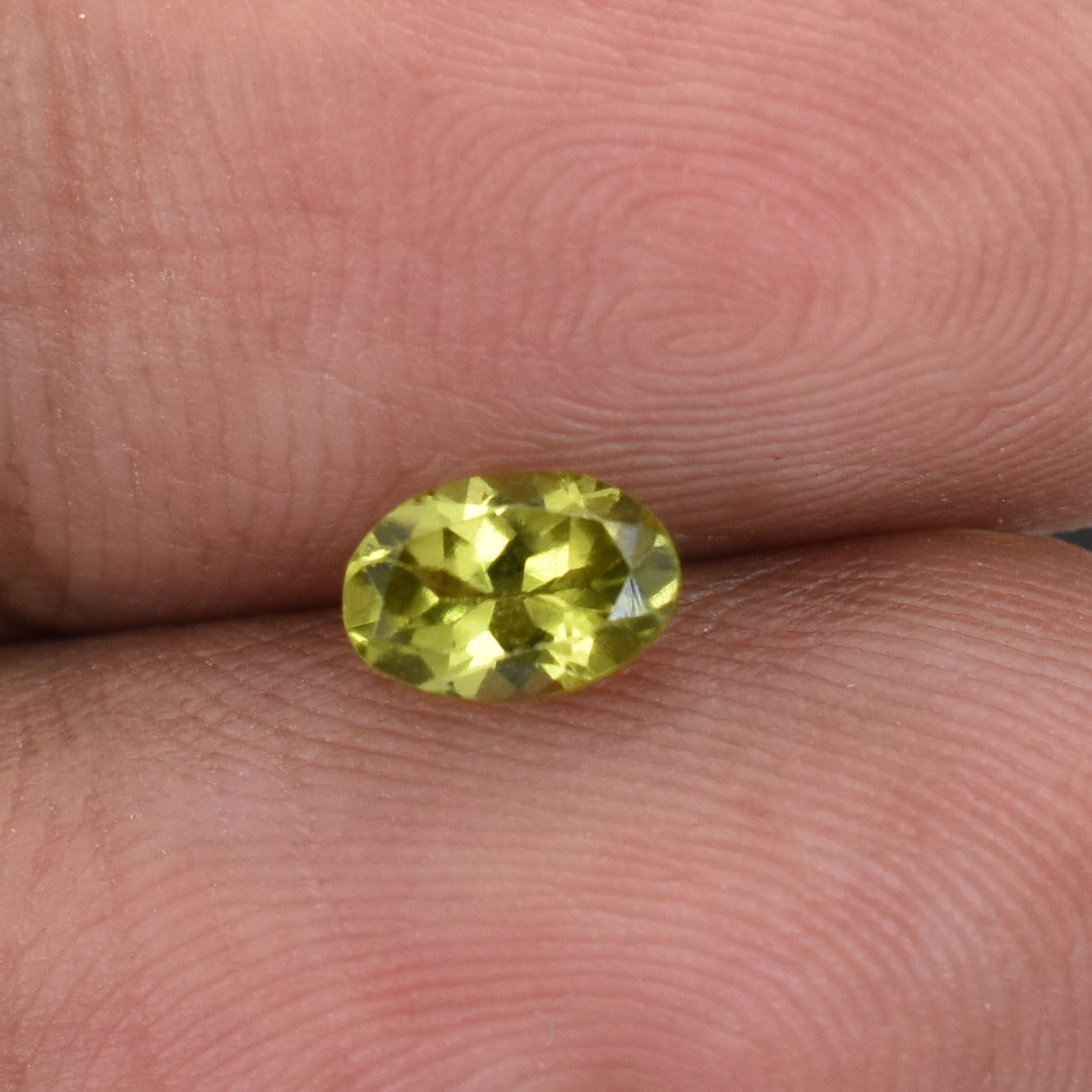 Oval-cut yellow gemstone, likely a citrine or yellow sapphire.