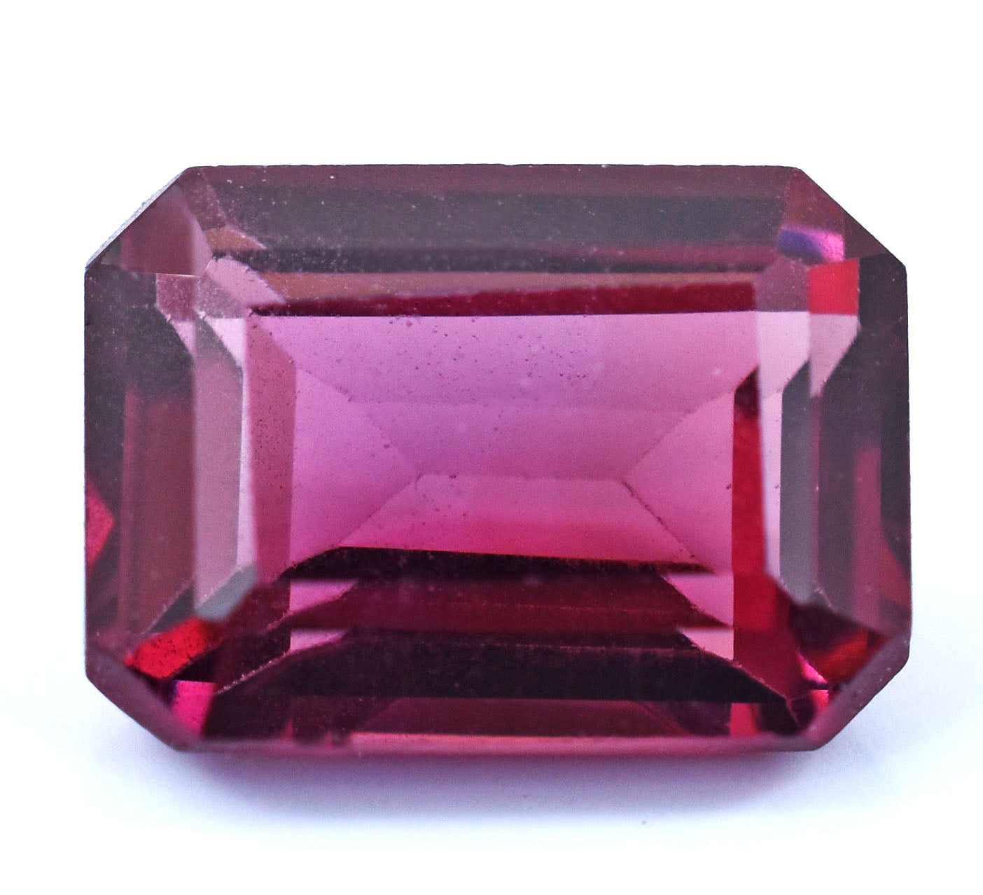 Emerald-cut pink gemstone with faceted edges.