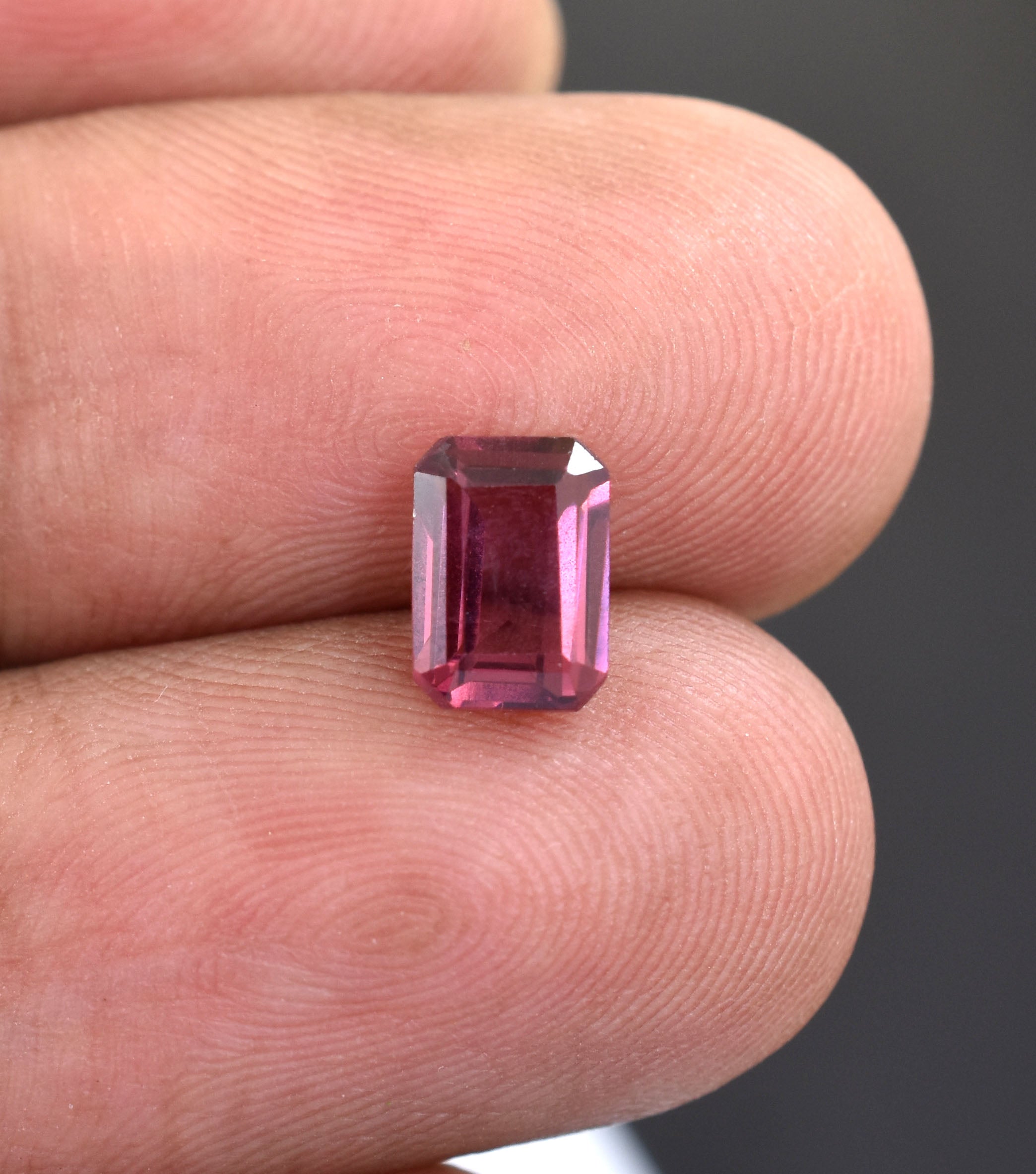 Pink gemstone with a rectangular emerald cut.