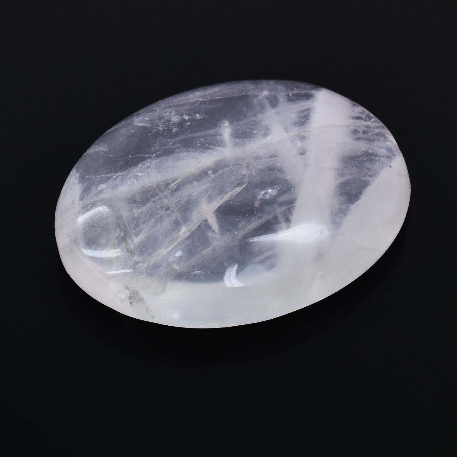 Oval-shaped, translucent gemstone with internal striations or inclusions.