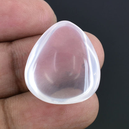 Transparent, teardrop-shaped silicone makeup applicator or beauty blender.