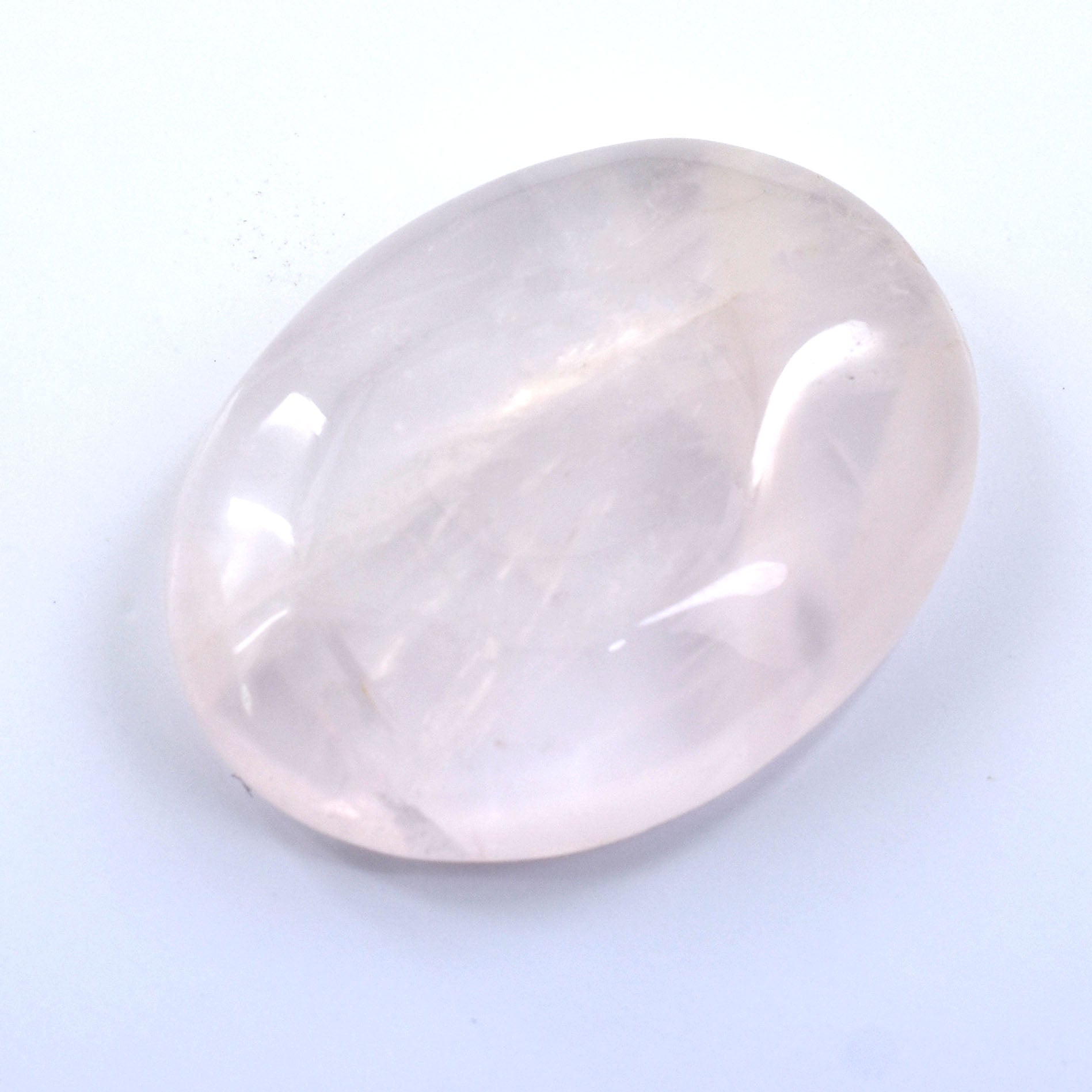 Smooth, oval-shaped rose quartz gemstone with a soft pink hue.