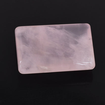 Rectangular piece of pale pink rose quartz with a smooth, polished surface.