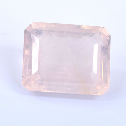 Pale pink rectangular gemstone with faceted edges.