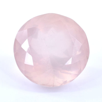 Pale pink gemstone with a round, faceted cut.