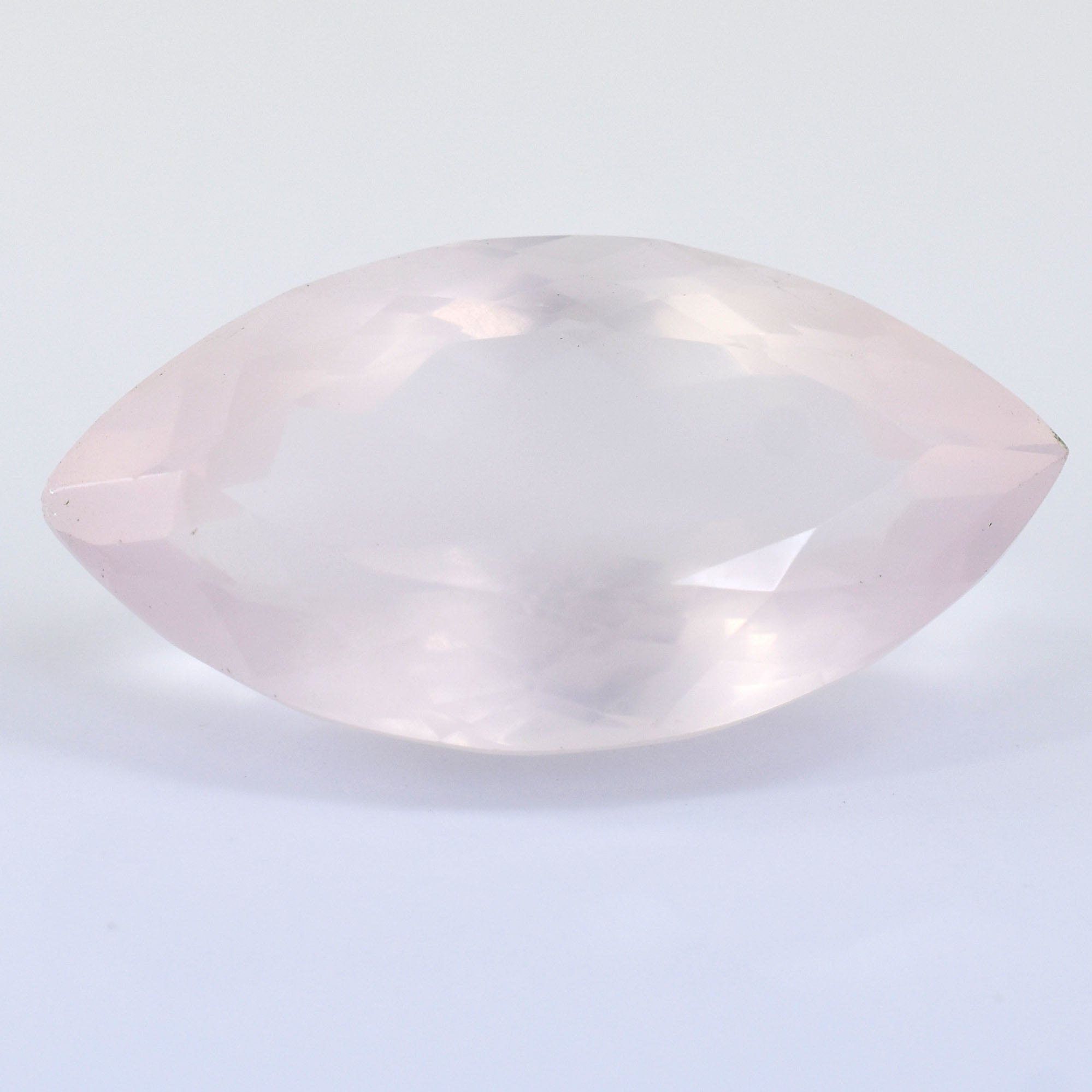 Pale pink marquise-cut gemstone or crystal with a smooth, polished surface.