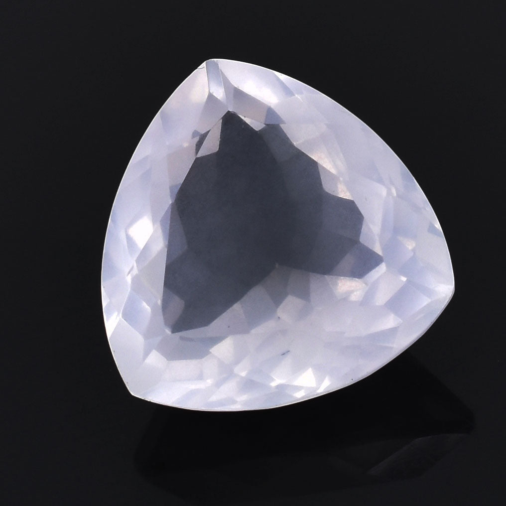 Triangular-cut gemstone with a pale, translucent appearance.