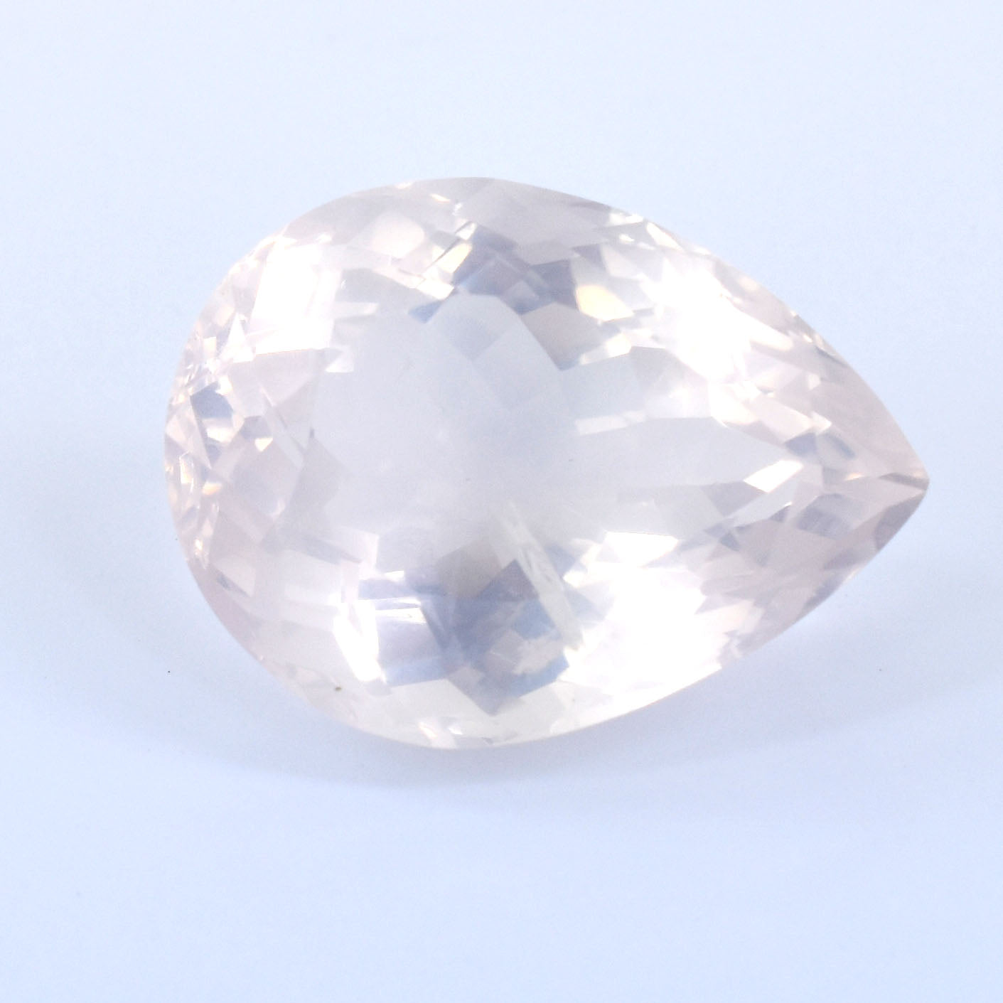 Pear-shaped clear gemstone or crystal with facets.