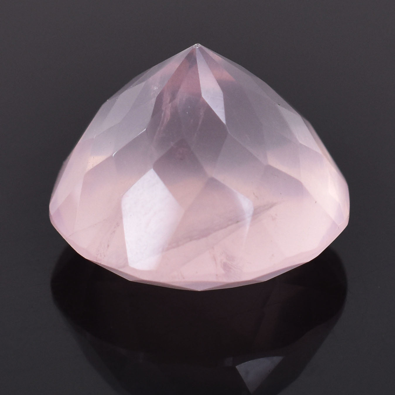 Pale pink faceted gemstone with a rounded teardrop shape.