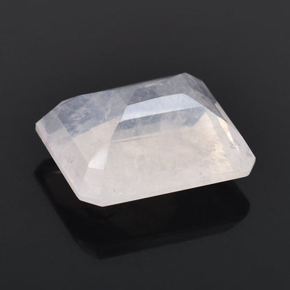 Faceted, translucent gemstone or crystal with a rectangular shape.